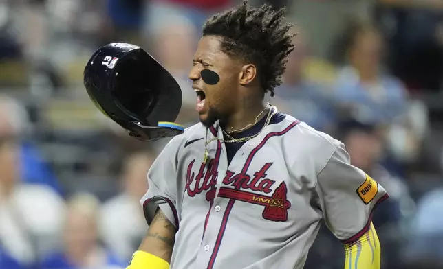 Atlanta Braves' Ronald Acuna Jr. celebrates after scoring on a three-run double hit by Austin Riley during the eighth inning of a baseball game against the Kansas City Royals, Monday, July 28, 2025, in Kansas City, Mo. (AP Photo/Charlie Riedel)