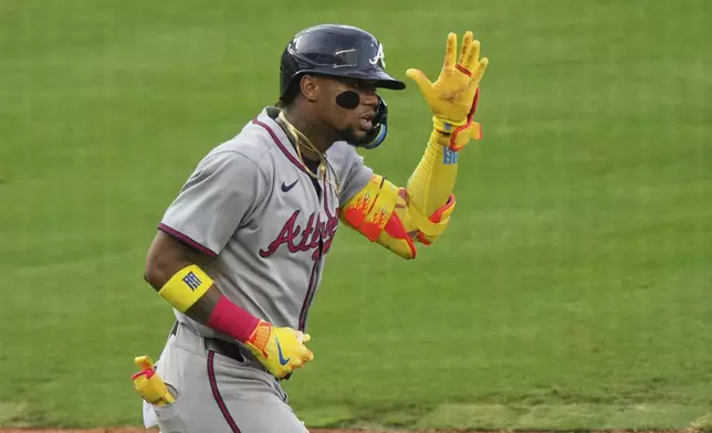 Atlanta Braves' Ronald Acuna Jr. celebrates after hitting a two-run home run during the third inning of a baseball game against the Kansas City Royals, Monday, July 28, 2025, in Kansas City, Mo. (AP Photo/Charlie Riedel)