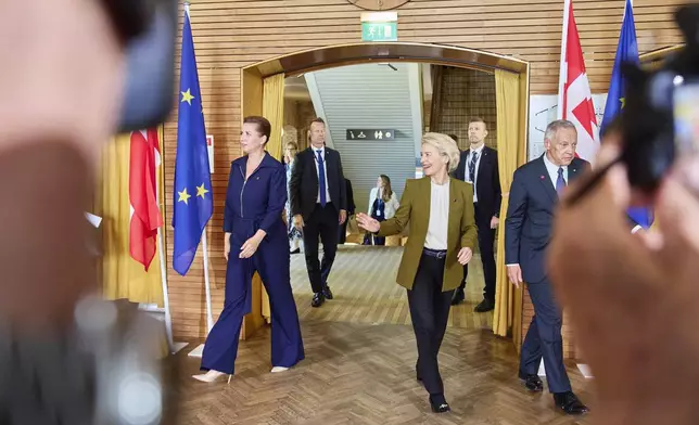Danish Prime Minister Mette Frederiksen, centre left, and President of the European Commission Ursula von der Leyen arrive for a round table at Aarhus University in Aarhus, Denmark, Thursday, July 3, 2025, as Denmark officially takes over the EU presidency. (Mikkel Berg Pedersen/Ritzau Scanpix via AP)