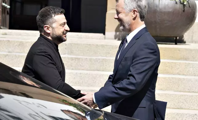 Denmark's King Frederik, right, receives Ukraine's President Volodymyr Zelenskyy as he arrives at Marselisborg Castle on the occasion of Denmark taking over the EU presidency, in Aarhus, Denmark, Thursday, July 3, 2025. (Henning Bagger/Ritzau Scanpix via AP)