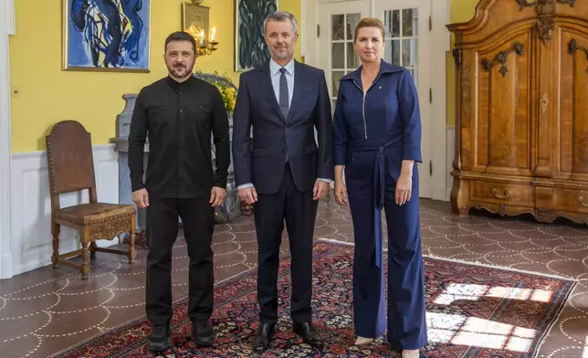 Denmark's King Frederik X receives Ukraine's President Volodymyr Zelenskyy, left, in an audience with Prime Minister Mette Frederiksen, right, at Marselisborg Palace in Aarhus, Denmark, Thursday July 3, 2025. (Ida Marie Odgaard/Ritzau Scanpix via AP)