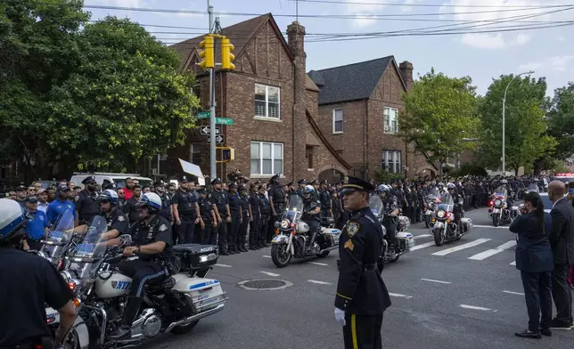 NYPD officers on motorcycle escorting an ambulance carrying a casket of NYPD Officer Didarul Islam arrive at Parkchester Jame Masjid after Monday's deadly shooting, Tuesday, July 29, 2025, in New York. (AP Photo/Yuki Iwamura)