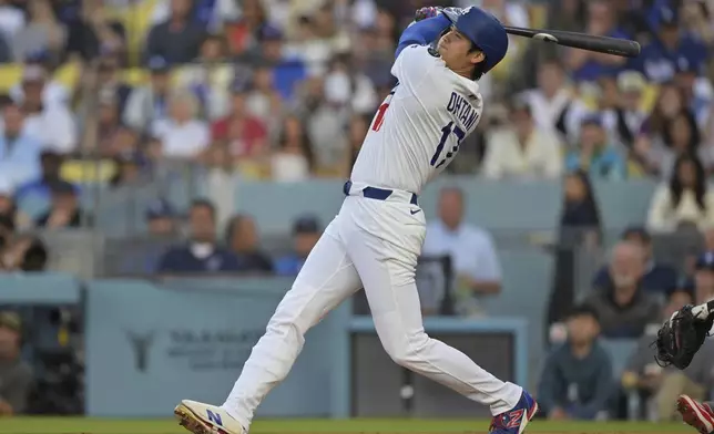 Los Angeles Dodgers' Shohei Ohtani hits a two-run home run during the first inning of a baseball game against the Minnesota Twins in Los Angeles, Monday, July 21, 2025. (AP Photo/Jayne Kamin-Oncea)