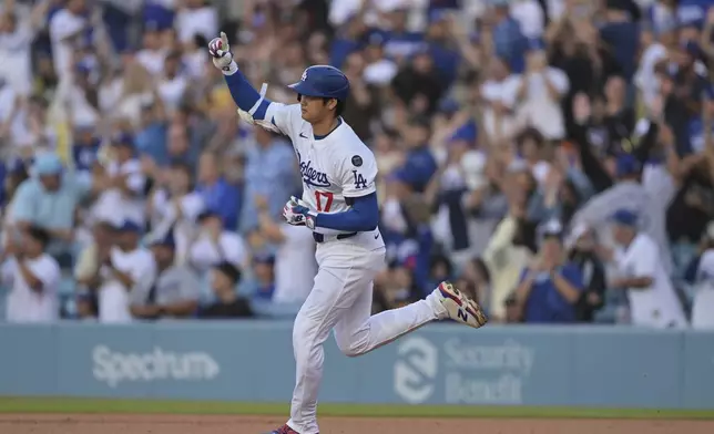 Los Angeles Dodgers pitcher Shohei Ohtani gestures after hitting a two-run home run during the first inning of a baseball game against the Minnesota Twins in Los Angeles, Monday, July 21, 2025. (AP Photo/Jayne Kamin-Oncea)