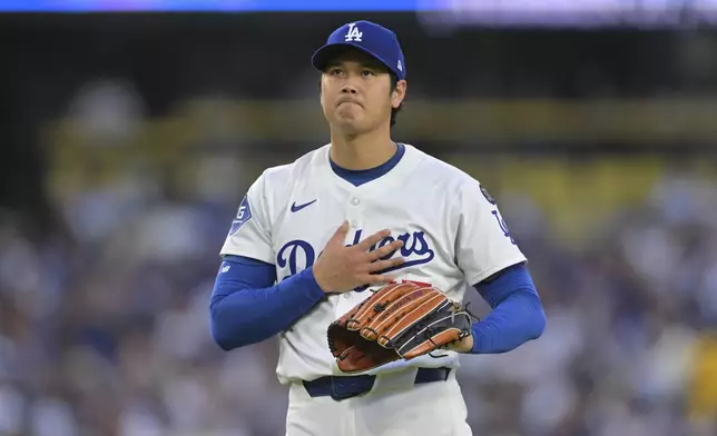 Los Angeles Dodgers pitcher Shohei Ohtani reacts after a base hit by Minnesota Twins' Ryan Jeffers during the third inning of a baseball game in Los Angeles, Monday, July 21, 2025. (AP Photo/Jayne Kamin-Oncea)