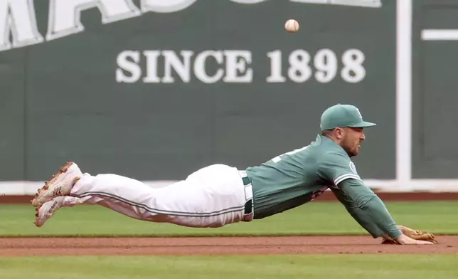 Boston Red Sox third baseman Alex Bregman dives for the ball on a left field single hit by Tampa Bay Rays' Junior Caminero during the first inning of a baseball game Friday, July 11, 2025, in Boston. (AP Photo/Mark Stockwell)