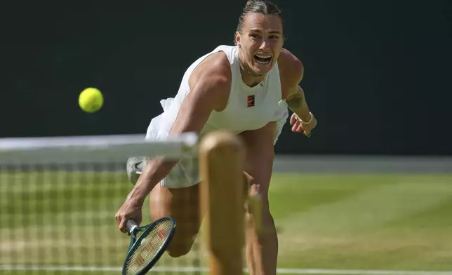 Aryna Sabalenka of Belarus returns to Amanda Anisimova of the U.S. during a women's singles semifinal match at the Wimbledon Tennis Championships in London, Thursday, July 10, 2025. (AP Photo/Kin Cheung)