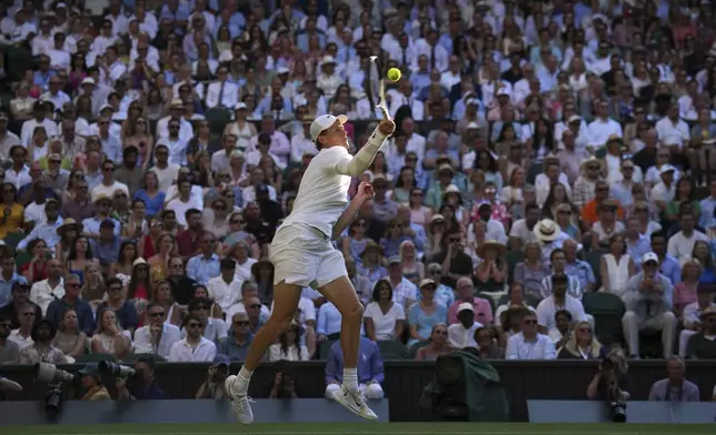 Italy's Jannik Sinner returns to Serbia's Novak Djokovic in a men's singles semifinal at the Wimbledon Tennis Championships in London, Friday, July 11, 2025. (AP Photo/Kin Cheung)