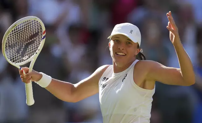 Poland's Iga Swiatek celebrates after beating Switzerland's Belinda Bencic during a women's singles semifinal match at the Wimbledon Tennis Championships in London, Thursday, July 10, 2025. (AP Photo/Kin Cheung)