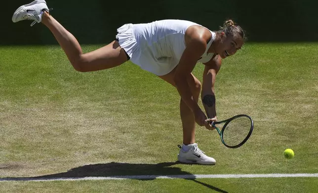 Aryna Sabalenka of Belarus returns to Amanda Anisimova of the U.S. during a women's singles semifinal match at the Wimbledon Tennis Championships in London, Thursday, July 10, 2025. (AP Photo/Joanna Chan)