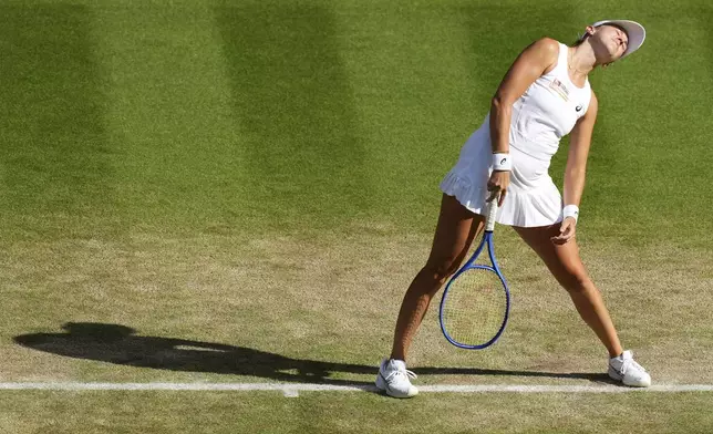 Switzerland's Belinda Bencic reacts as she plays Poland's Iga Swiatek during a women's singles semifinal match at the Wimbledon Tennis Championships in London, Thursday, July 10, 2025. (AP Photo/Joanna Chan)