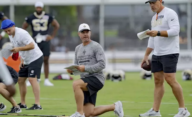 New Orleans Saints defensive coordinator Brandon Staley, center, coaches during the team's NFL football training camp in Metairie, La., Wednesday, July 23, 2025. (AP Photo/Matthew Hinton)