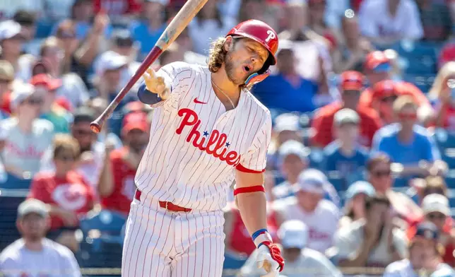 Philadelphia Phillies' Alec Bohm throws his bat after striking out in the eighth inning of a baseball game against the Cincinnati Reds, Friday, July 4, 2025, in Philadelphia. (AP Photo/Laurence Kesterson)