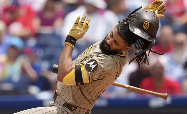 San Diego Padres' Fernando Tatis Jr. avoids a pitch from Philadelphia Phillies' Mick Abel during the second inning in the first baseball game of a doubleheader Wednesday, July 2, 2025, in Philadelphia. (AP Photo/Matt Slocum)