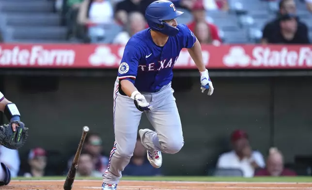Texas Rangers' Corey Seager heads to first for a single during the first inning of a baseball game against the Los Angeles Angels, Thursday, July 10, 2025 in Anaheim, Calif. (AP Photo/Mark J. Terrill)