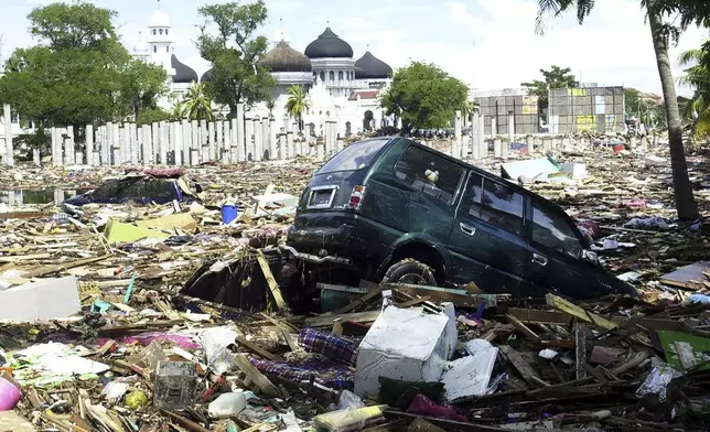 In this Dec. 27, 2004 file photo, debris litter the front lawn of Baiturrahman Grand Mosque after gigantic waves swept in Banda Aceh, Aceh province, Indonesia. (AP Photo/Achmad Ibrahim, File)
