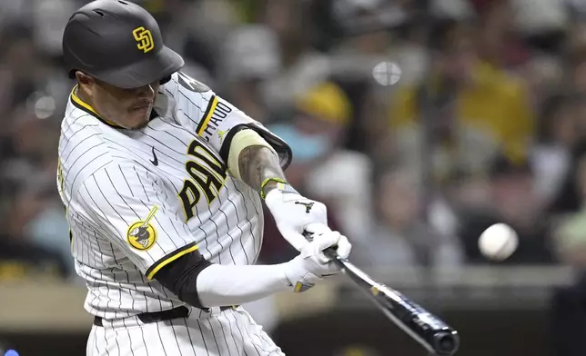 San Diego Padres' Manny Machado hits a home run against the Arizona Diamondbacks during the eighth inning of a baseball game against the Arizona Diamondbacks Monday, July 7, 2025, in San Diego. (AP Photo/Orlando Ramirez)