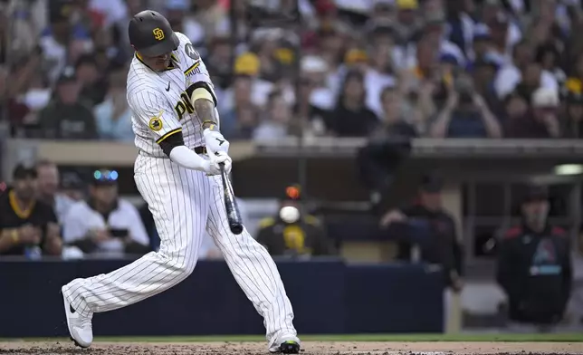 San Diego Padres' Manny Machado hits a single, his 2000th career hit, during the fourth inning of a baseball game against the Arizona Diamondbacks Monday, July 7, 2025, in San Diego. (AP Photo/Orlando Ramirez)