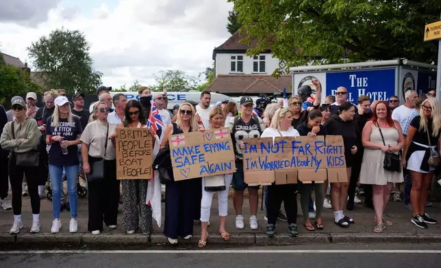 Protesters demonstrate outside the Bell Hotel in the town of Epping, Essex, England, Sunday, July 20, 2025. (Yui Mok/PA via AP)