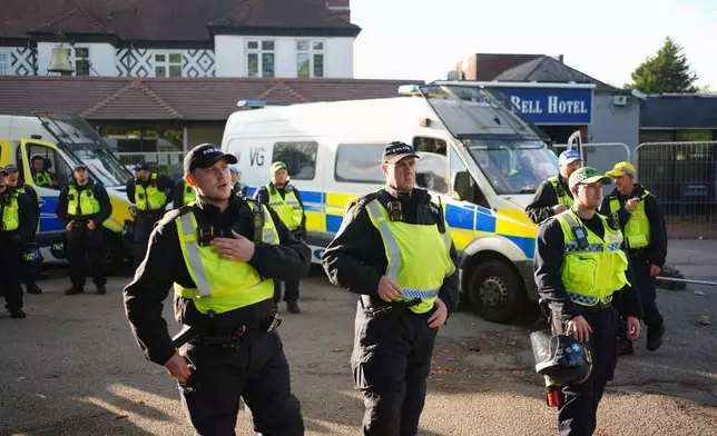 Police gather outside the Bell Hotel in the town of Epping, Essex, England, during a protest against asylum seekers, northeast of London, Sunday, July 20, 2025. (Yui Mok/PA via AP)