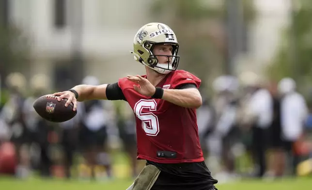New Orleans Saints quarterback Tyler Shough (6) goes through drills during an NFL football training camp in Metairie, La., Thursday, July 24, 2025. (AP Photo/Gerald Herbert)
