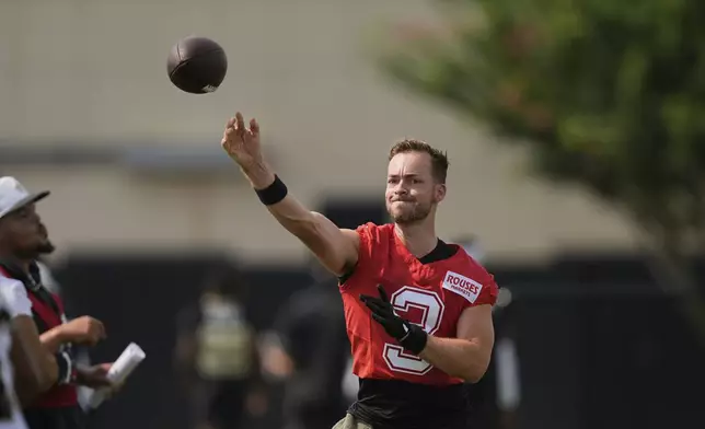 New Orleans Saints quarterback Jake Haener (3) goes through drills during an NFL football training camp in Metairie, La., Thursday, July 24, 2025. (AP Photo/Gerald Herbert)
