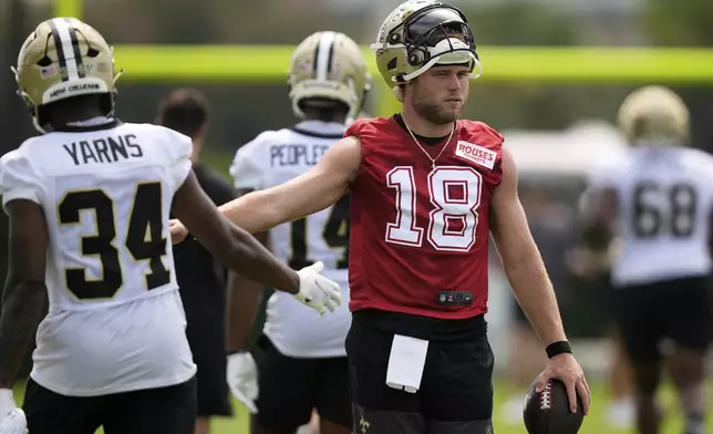 New Orleans Saints quarterback Hunter Dekkers (18) goes through drills with running back Marcus Yarns (34) during an NFL football training camp in Metairie, La., Thursday, July 24, 2025. (AP Photo/Gerald Herbert)