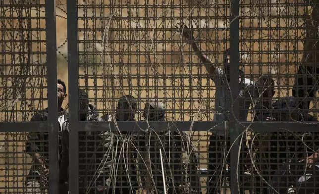 Syrian Druze protest near the Israeli-Syrian border, as seen from the town of Majdal Shams in the Israeli-controlled Golan Heights, Wednesday, July 16, 2025, amid the ongoing clashes between Syrian government forces and Druze armed groups in the southern Syrian city of Sweida. (AP Photo/Leo Correa)