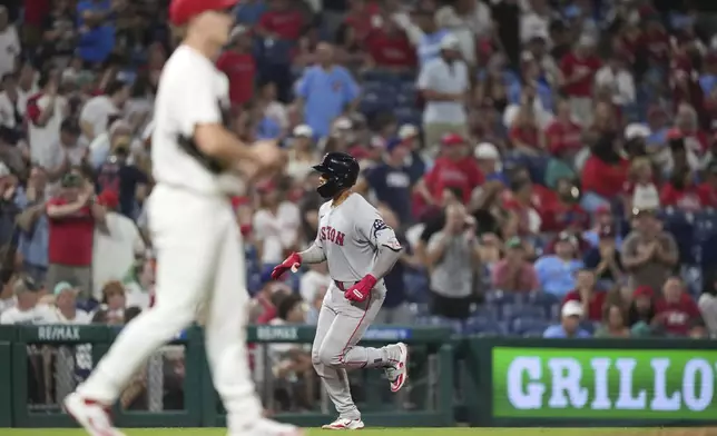 Boston Red Sox's Carlos Narváez, right, rounds the bases after hitting a go-ahead two-run home run against Philadelphia Phillies pitcher Seth Johnson during the 11th inning of a baseball game Wednesday, July 23, 2025, in Philadelphia. (AP Photo/Matt Slocum)