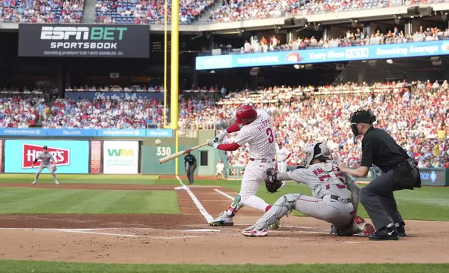 Philadelphia Phillies' Bryce Harper hits a home run against Boston Red Sox pitcher Lucas Giolito during the first inning of a baseball game Wednesday, July 23, 2025, in Philadelphia. (AP Photo/Matt Slocum)