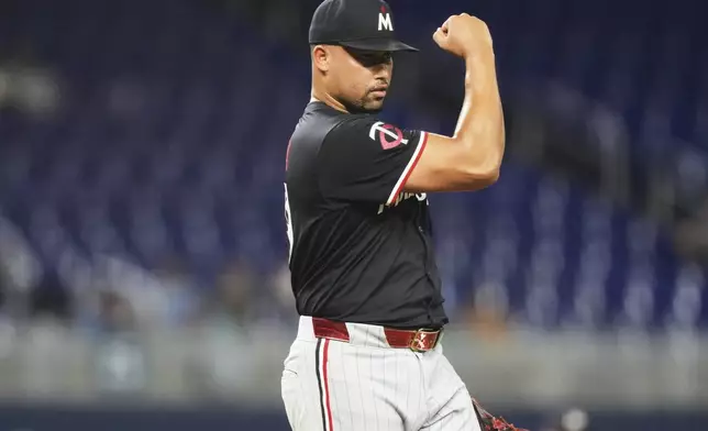 Minnesota Twins relief pitcher Jhoan Duran reacts after getting the final out during the ninth inning of a baseball game against the Miami Marlins, Wednesday, July 2, 2025, in Miami. (AP Photo/Lynne Sladky)