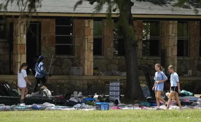 FILE - People sort through personal items at Camp Mystic in Hunt, Texas, on Wednesday, July 9, 2025. (AP Photo/Ashley Landis, File)