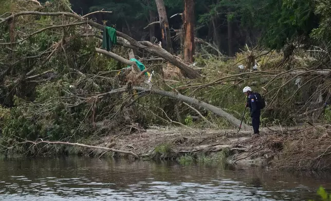 FILE - Search and rescue teams comb the banks of the Guadalupe River after a flash flood swept through the area, Saturday, July 12, 2025, in Kerrville, Texas. (AP Photo/Eric Gay, File)