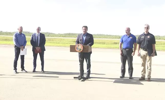 This image from a video feed shows Gov. Ron DeSantis speaking about deportation flights from the remote Everglades immigration lockup known as ”Alligator Alcatraz″ on July 25, 2025 in Ochopee, Florida. (Office Of Florida Governor Ron Desantis via AP)
