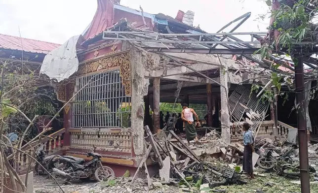 People check the debris at the building in a Buddhist monastery that was allegedly hit by the military’s airstrike in Sagaing township in Sagaing region, Myanmar, Friday, July 11, 2025. (UGC via AP)