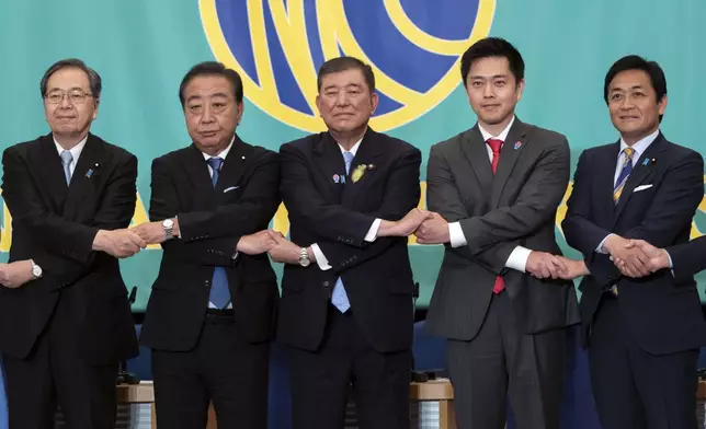 Leaders of eight political parties, from left to right, Komeito Chief Representative Tetsuo Saito, Constitutional Democratic Party of Japan leader Yoshihiko Noda, Japan's Prime Minister and Liberal Democratic Party leader Shigeru Ishiba, Japan Innovation Party Co-Representative Hirofumi Yoshimura and Democratic Party For the People Representative Yuichiro Tamaki pose before a debate at the Japan National Press Club in Tokyo, Japan, on July 2, 2025. (Tomohiro Ohsumi/Pool Photo via AP)