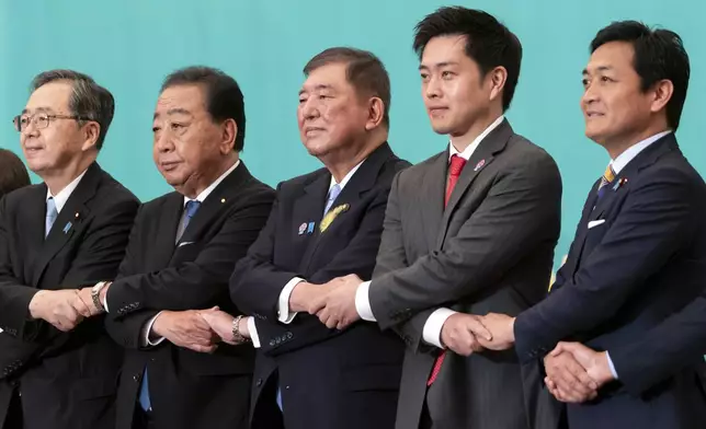 Leaders of eight political parties, from left to right, Komeito Chief Representative Tetsuo Saito, Constitutional Democratic Party of Japan leader Yoshihiko Noda, Japan's Prime Minister and Liberal Democratic Party leader Shigeru Ishiba, Japan Innovation Party Co-Representative Hirofumi Yoshimura and Democratic Party For the People Representative Yuichiro Tamaki pose before a debate at the Japan National Press Club in Tokyo, Japan, Wednesday, July 2, 2025. (Tomohiro Ohsumi/Pool Photo via AP)