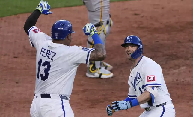 Kansas City Royals' Nick Loftin (12) celebrates with Salvador Perez (13) after hitting a two-run home run during the seventh inning of a baseball game against the Pittsburgh Pirates Tuesday, July 8, 2025, in Kansas City, Mo. (AP Photo/Charlie Riedel)