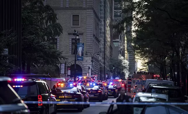 The scene on 52nd Street between Park and Lexington Avenue where a New York Police Department police officer was shot, Monday, July 28, 2025, in New York. (AP Photo/Angelina Katsanis)