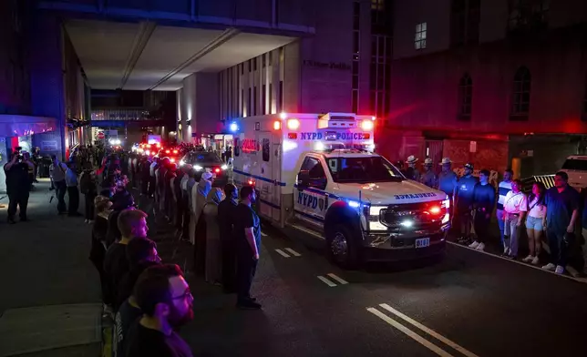 The ambulance carrying the body of Didarul Islam exits NewYork-Presbyterian/Weill Cornell Medical Hospital during the dignified transfer of the slain officer, who was shot and killed by a gunman Monday evening, early Tuesday, July 29, 2025, in New York. (AP Photo/Angelina Katsanis)