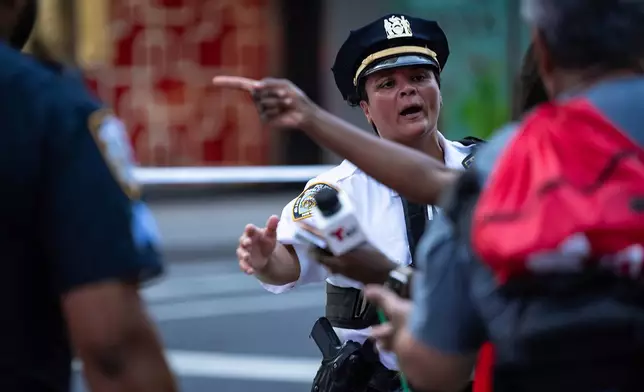 The scene on 52nd Street between Park and Lexington Avenue where a New York Police Department police officer was shot, Monday, July 28, 2025, in New York. (AP Photo/Angelina Katsanis)