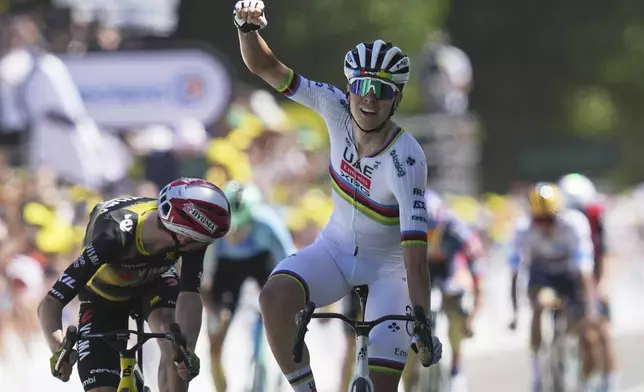 Slovenia's Tadej Pogacar celebrates as he crosses the finish line to win the seventh stage of the Tour de France cycling race over 197 kilometers (122.4 miles) with start in Saint-Malo and finish in Mur-de-Bretagne Guerledan, France, Friday, July 11, 2025. (AP Photo/Thibault Camus)