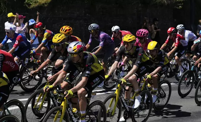 The pack rides during the seventh stage of the Tour de France cycling race over 197 kilometers (122.4 miles) with start in Saint-Malo and finish in Mur-de-Bretagne Guerledan, France, Friday, July 11, 2025. (AP Photo/Mosa'ab Elshamy)