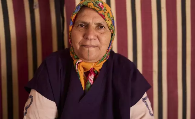 Fatima Bensaid, who works at a cooperative that extracts and produces argan oil and products, poses for a portrait, in Essaouira, Morocco, Thursday, May 22, 2025. (AP Photo/Mosa'ab Elshamy)