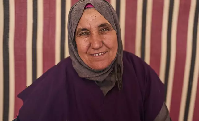 Kharra Tlaytmass, who works at a cooperative that extracts and produces argan oil and products, poses for a portrait, Essaouira, Morocco, Thursday, May 22, 2025. (AP Photo/Mosa'ab Elshamy)