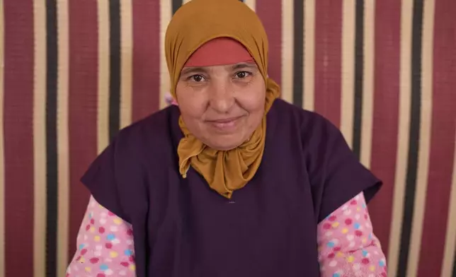 Rabiaa Reshmayn, who works at a cooperative that extracts and produces argan oil and products, poses for a portrait, in Essaouira, Morocco, Thursday, May 22, 2025. (AP Photo/Mosa'ab Elshamy)
