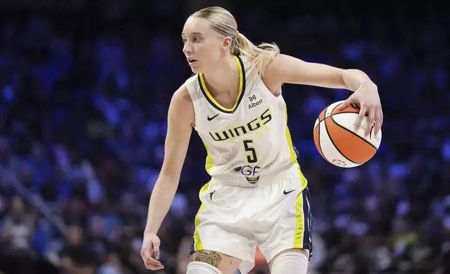 Dallas Wings guard Paige Bueckers handles the ball as she works against the Phoenix Mercury in the second half of a WNBA basketball game Thursday, July 3, 2025, in Arlington, Texas. (AP Photo/Tony Gutierrez)