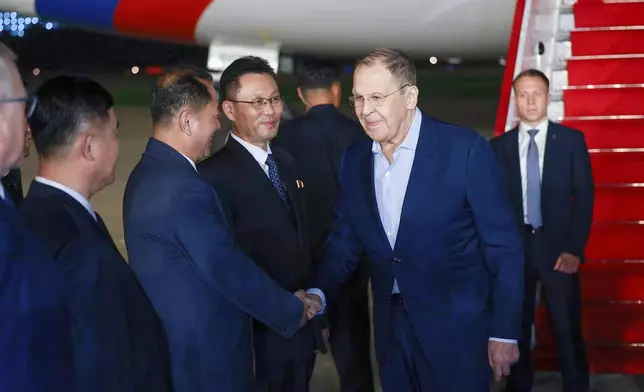 In this photo provided by the Russian Foreign Ministry Press Service, Russian Foreign Minister Sergey Lavrov, second right, shakes hands with North Korean officials upon his arrival at an airport outside Pyongyang, North Korea, on Friday, July 11, 2025. (Russian Foreign Ministry Press Service via AP)