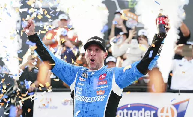 Denny Hamlin celebrates in Victory Lane after winning a NASCAR Cup Series auto race at Dover Motor Speedway, Sunday, July 20, 2025, in Dover, Del. (AP Photo/Derik Hamilton)