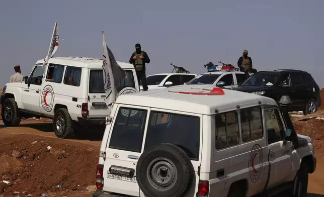 A convoy of ambulances and buses arrives at a checkpoint in the village of Busra al-Harir, southern Syria, on its way to Sweida province, as security forces cordon off the area to block Bedouin fighters from entering the province, Tuesday, July 22, 2025. (AP Photo/Omar Sanadiki)